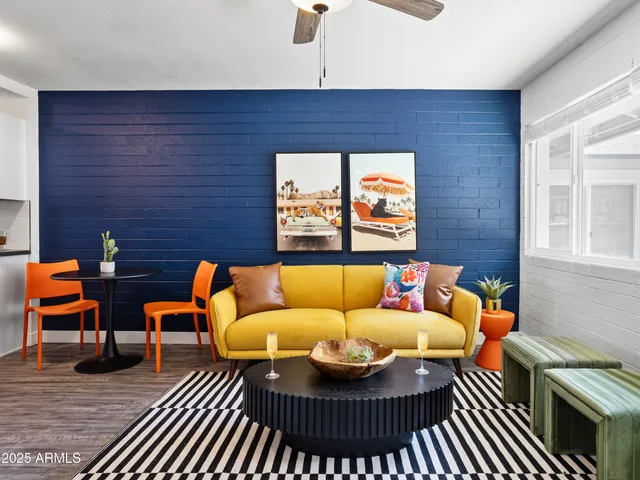 a living room with furniture a rug and a window