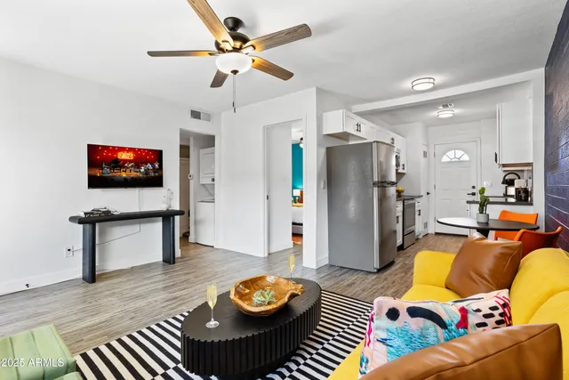 a living room with furniture and a wooden floor