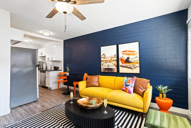 a living room with furniture and a chandelier