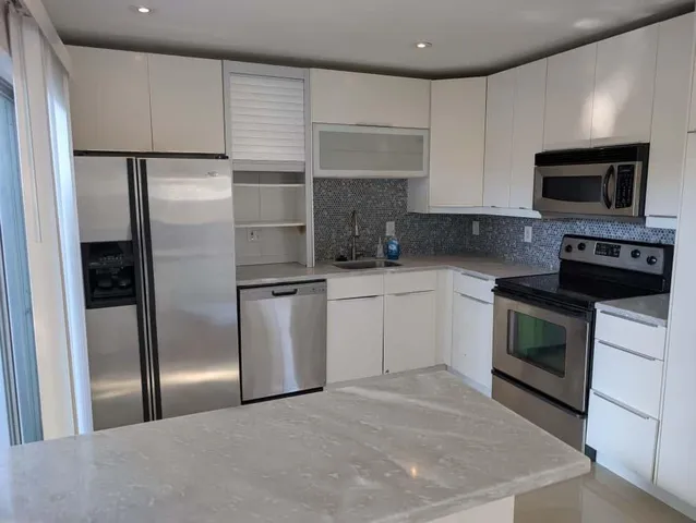 a kitchen with a refrigerator stove and microwave