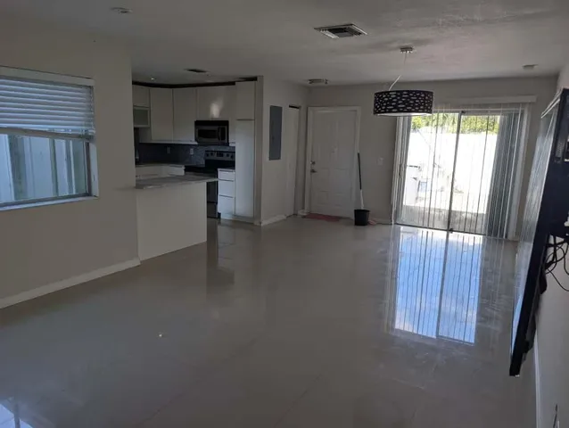 a view of a kitchen with a sink cabinets and a window