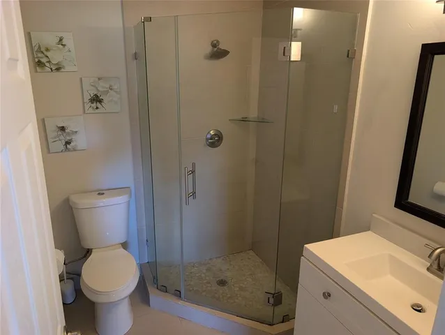 a bathroom with a sink toilet and shower