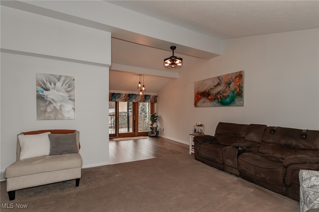 12745 Carter Road Painesville, OH 44077 - Photo 11 of 50 Living room with carpet flooring and a chandelier