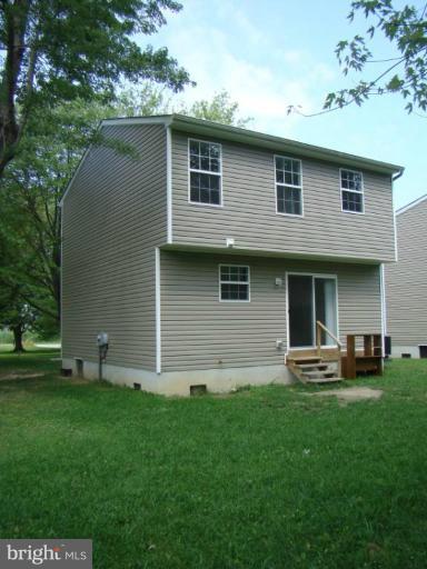 241 Perrys Corner Road Grasonville, MD 21638 - Photo 2 of 7 a front view of a house with garden
