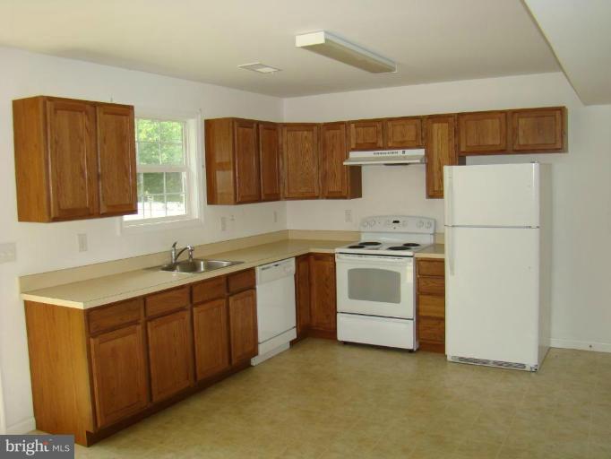 241 Perrys Corner Road Grasonville, MD 21638 - Photo 3 of 7 a view of a kitchen with stove and cabinets