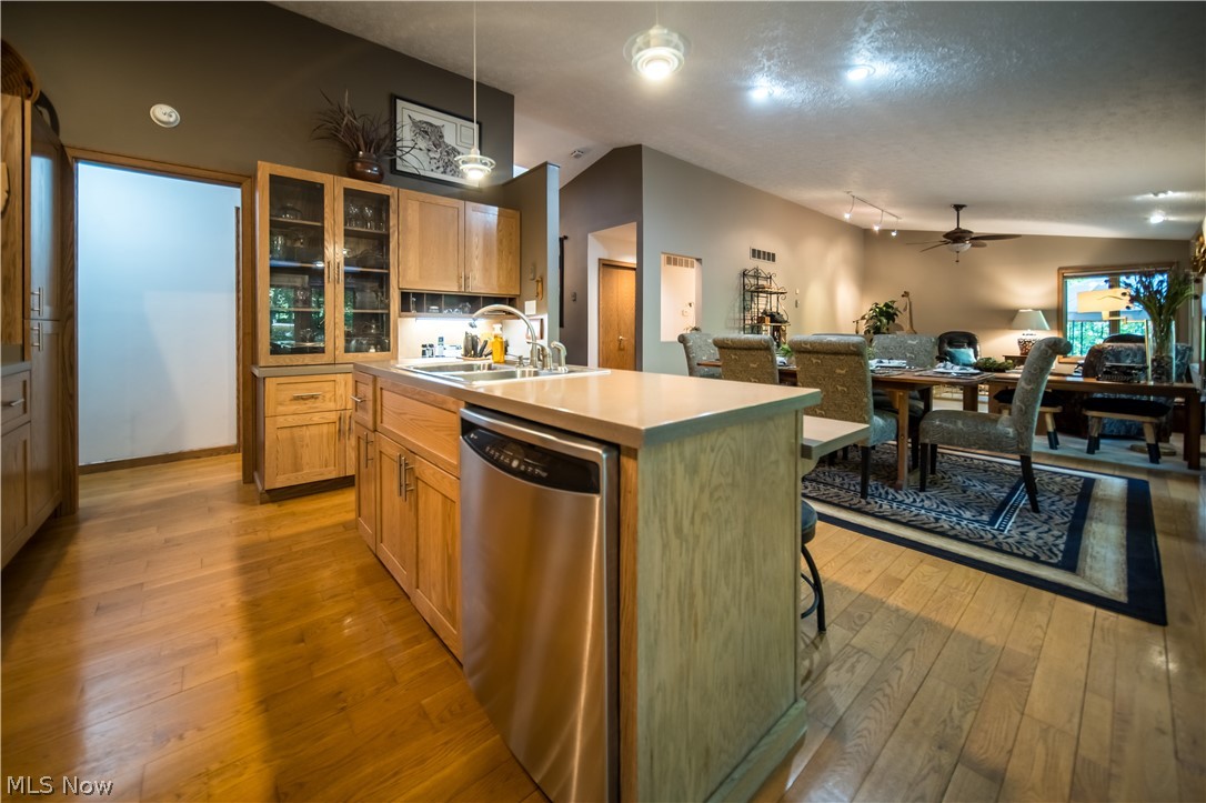 5119 Hattrick Road Ravenna, OH 44266 - Photo 12 of 33 Kitchen featuring light wood-type flooring, stainless steel dishwasher, an island with sink, sink, and ceiling fan