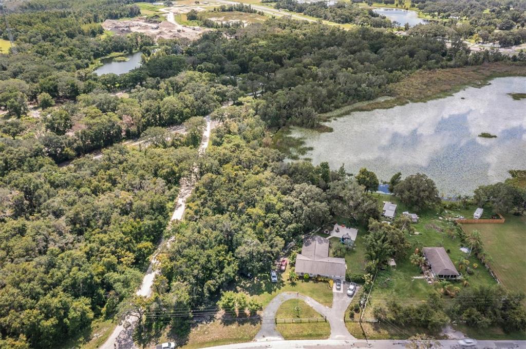 0 Giddens Road Spring Hill, FL 34610 - Photo 3 of 16 an aerial view of residential house with outdoor space and trees around