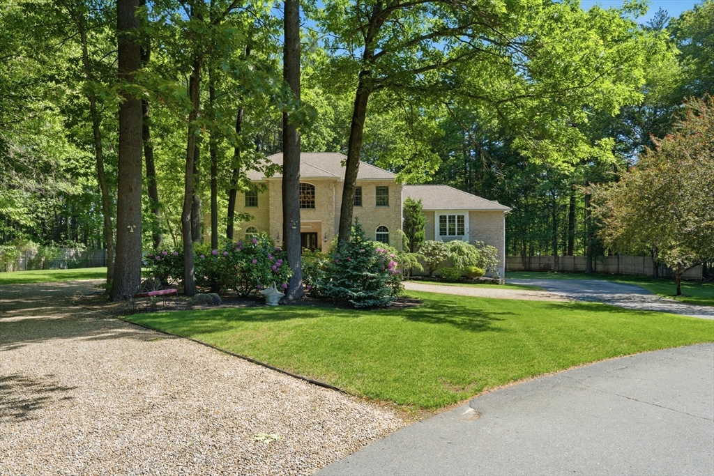 25 Haymeadow Road Boxford, MA 01921 - Photo 6 of 42 a front view of a house with a yard and trees