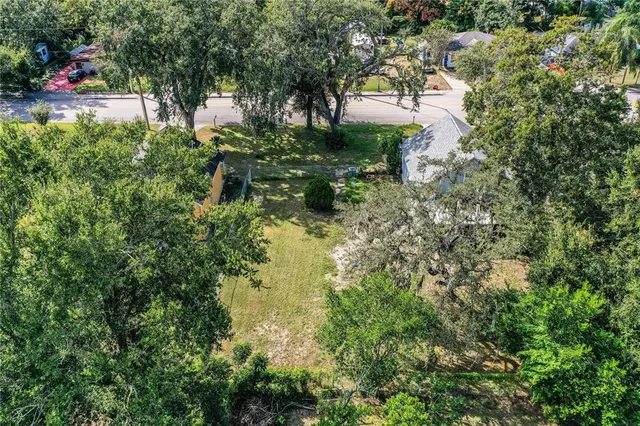 an aerial view of a house with yard swimming pool and outdoor seating