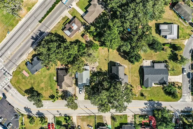 an aerial view of a residential apartment building with a yard