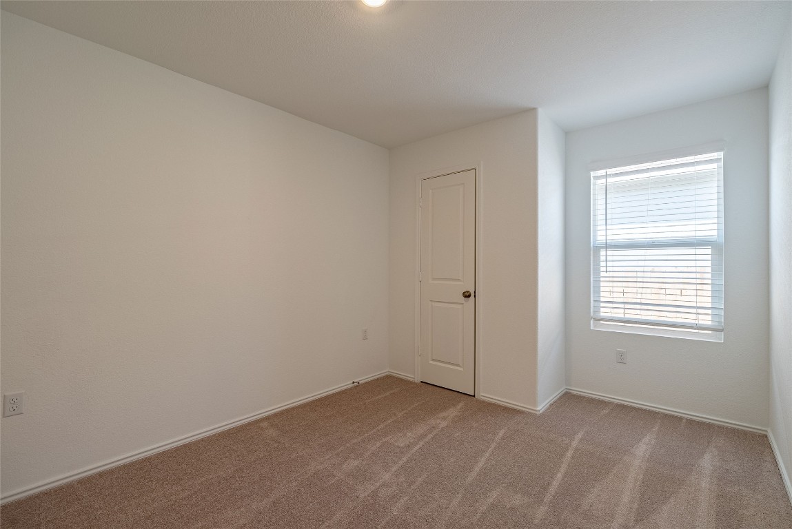 2509 Willkomen Way Pflugerville, TX 78660 - Photo 11 of 20 Carpeted spare room with baseboards
