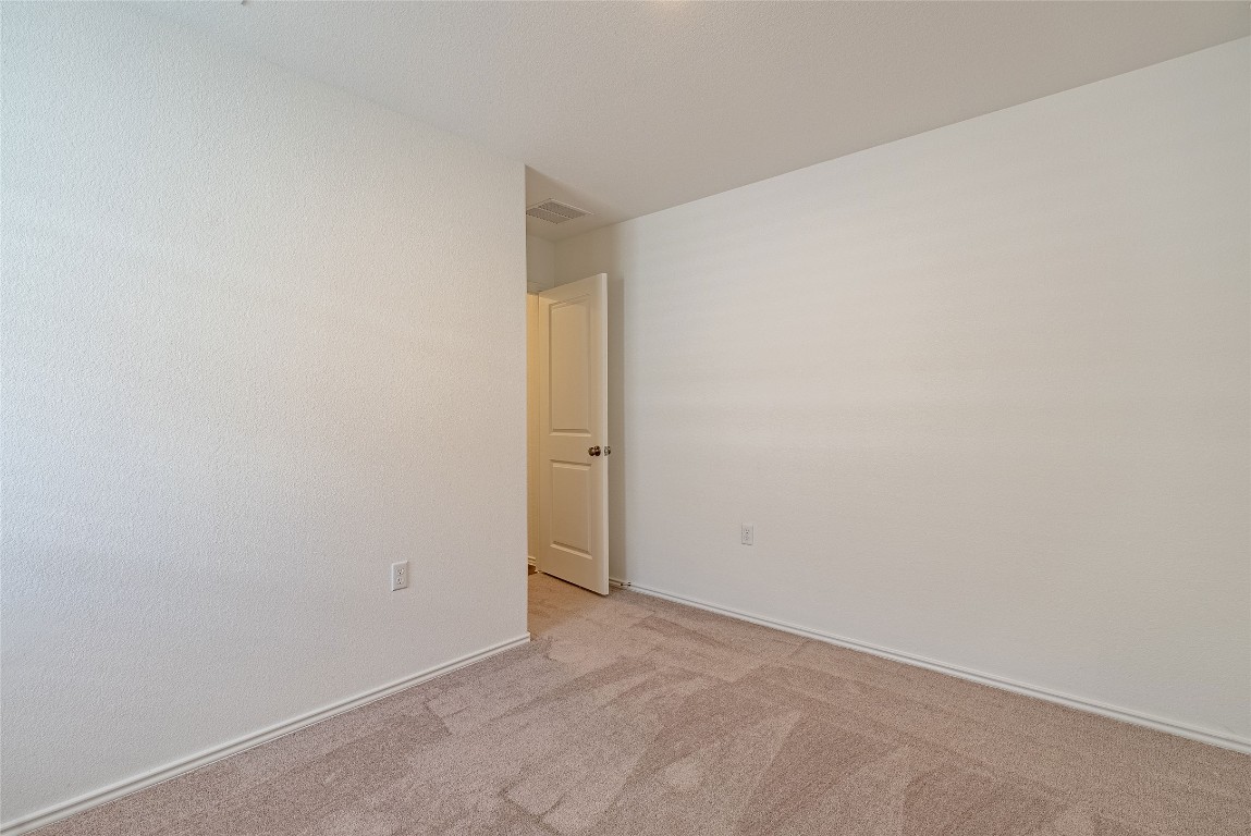 2509 Willkomen Way Pflugerville, TX 78660 - Photo 12 of 20 Spare room featuring carpet floors and baseboards