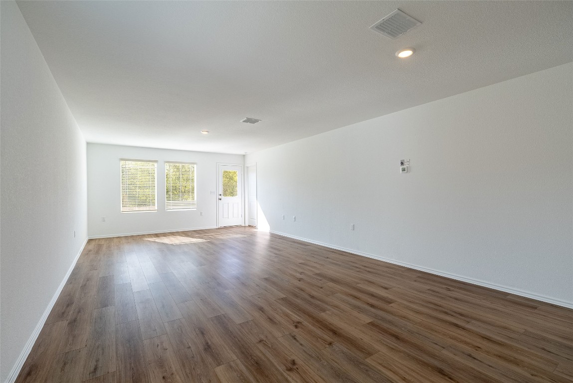 2509 Willkomen Way Pflugerville, TX 78660 - Photo 13 of 20 Unfurnished room featuring dark wood-style floors and recessed lighting