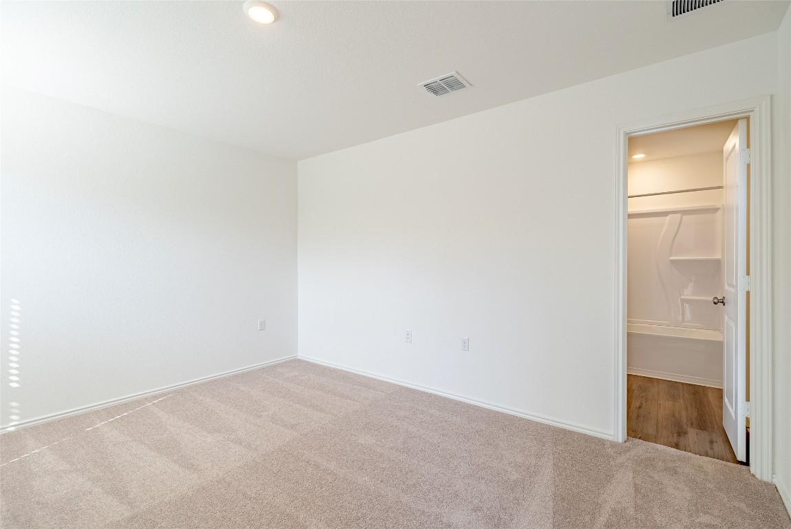 2509 Willkomen Way Pflugerville, TX 78660 - Photo 15 of 20 Unfurnished bedroom featuring recessed lighting, carpet floors, and connected bathroom