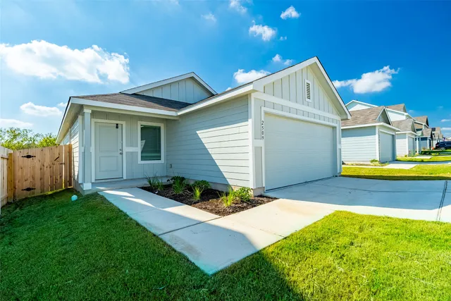 a view of a house with a yard and porch