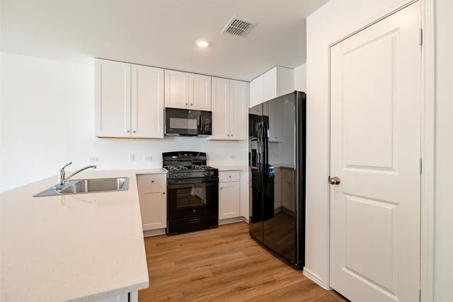 a kitchen with a refrigerator stove and sink