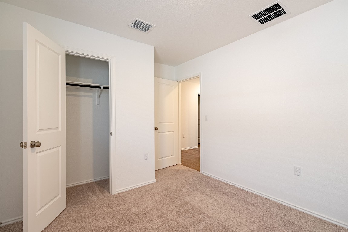 2509 Willkomen Way Pflugerville, TX 78660 - Photo 10 of 20 Unfurnished bedroom with light colored carpet and a closet