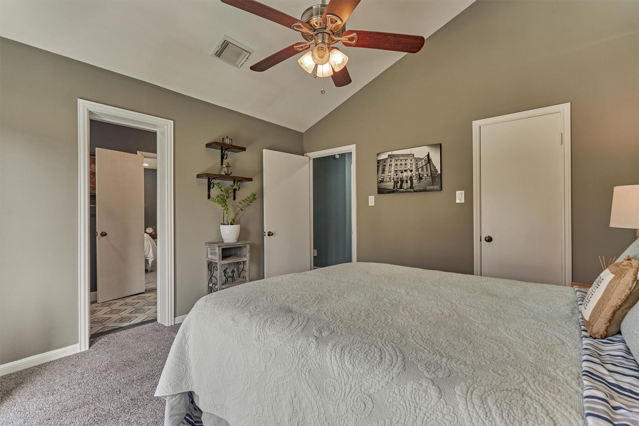 1 April Point Drive South Montgomery, TX 77356 - Photo 26 of 45 a spacious bedroom with a bed and a chandelier
