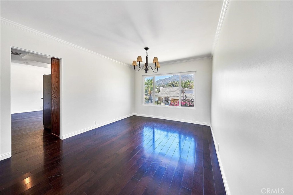416 Meadowview Drive La Canada Flintridge, CA 91011 - Photo 11 of 35 an empty room with wooden floor chandelier and windows