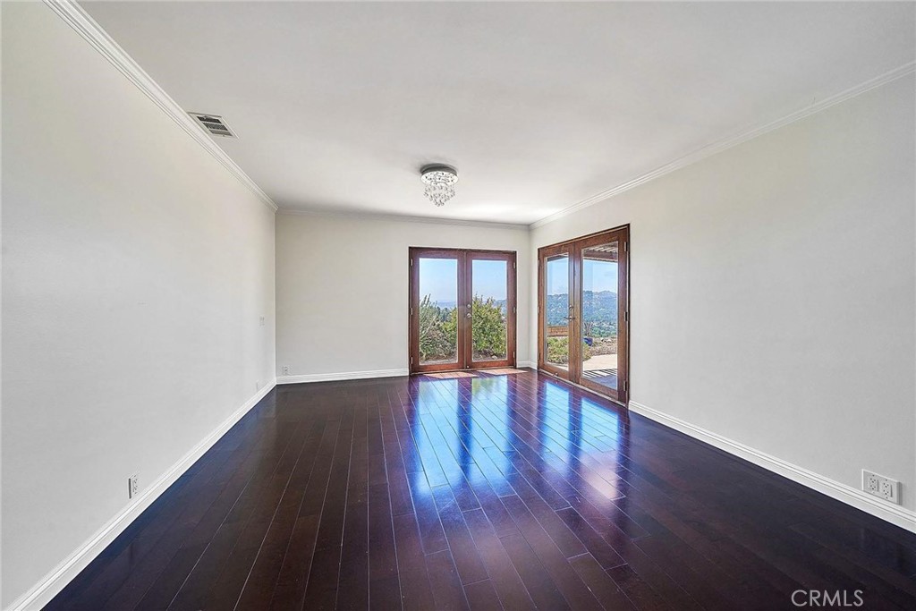 416 Meadowview Drive La Canada Flintridge, CA 91011 - Photo 15 of 35 a view of an empty room with wooden floor and a window