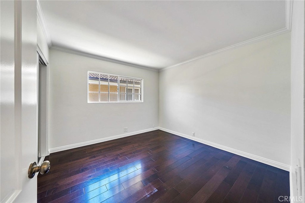 416 Meadowview Drive La Canada Flintridge, CA 91011 - Photo 16 of 35 an empty room with wooden floor and windows