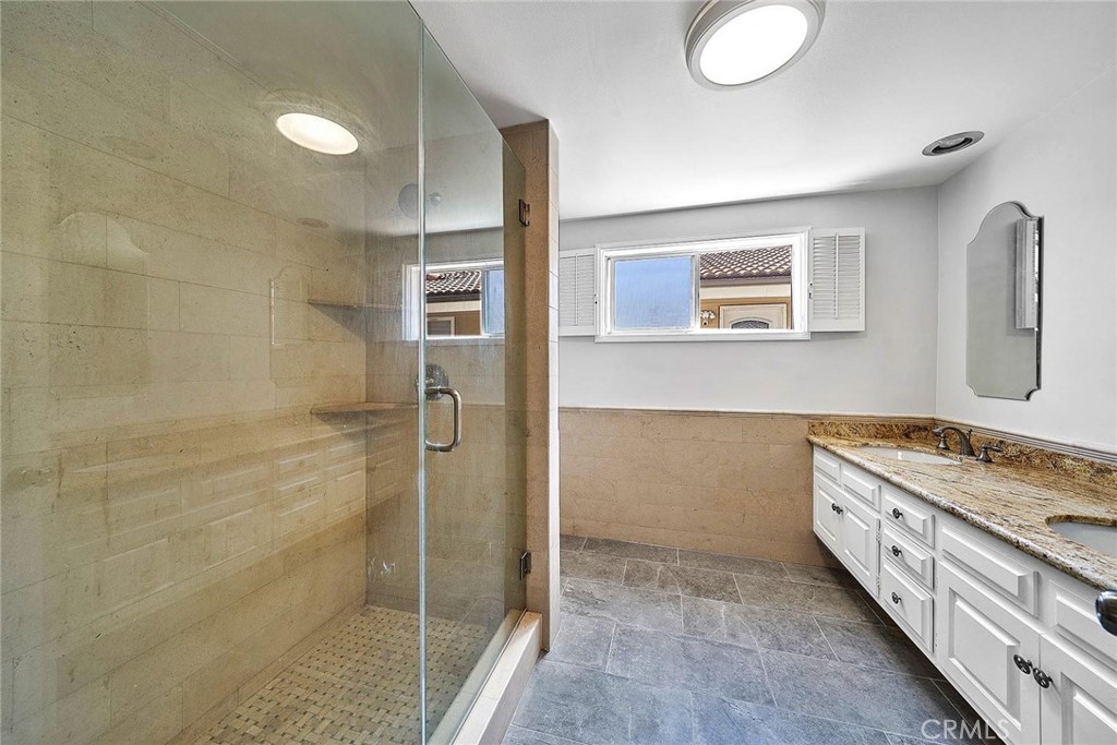 416 Meadowview Drive La Canada Flintridge, CA 91011 - Photo 20 of 35 a bathroom with a double vanity sink and a mirror
