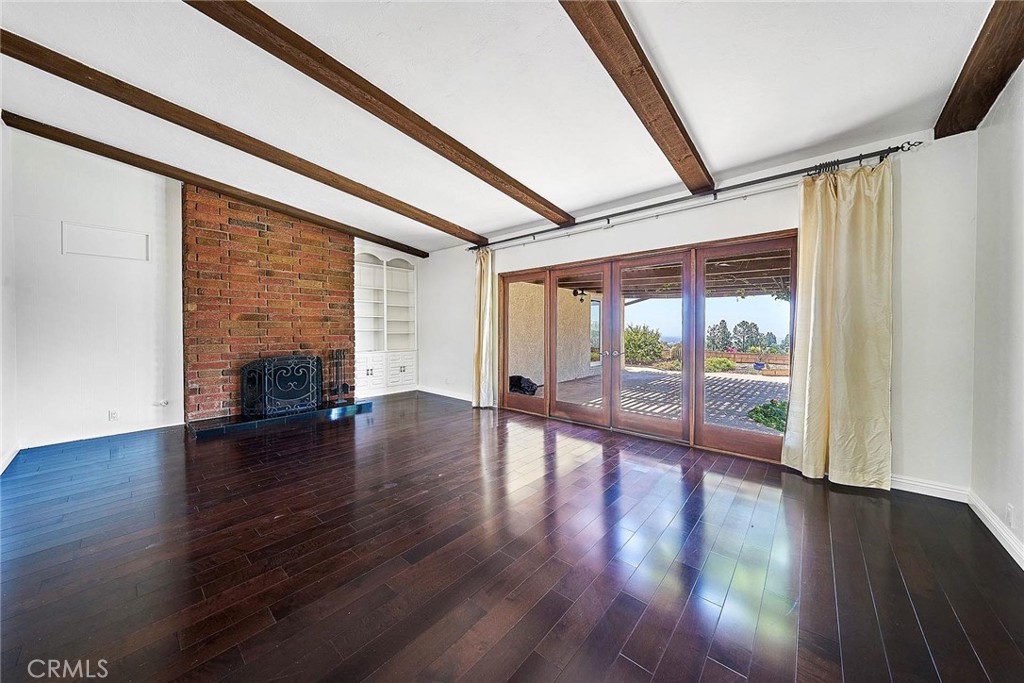 416 Meadowview Drive La Canada Flintridge, CA 91011 - Photo 5 of 35 a view of empty room with wooden floor and fireplace