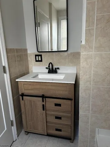 a bathroom with a sink a vanity and a mirror