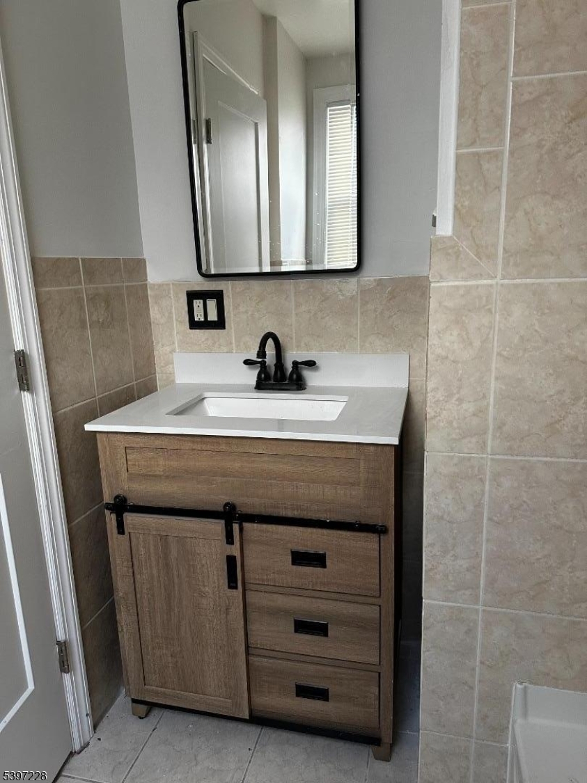 33 Hayward Place, Unit 2 Wallington, NJ 07057 - Photo 9 of 9 a bathroom with a sink a vanity and a mirror