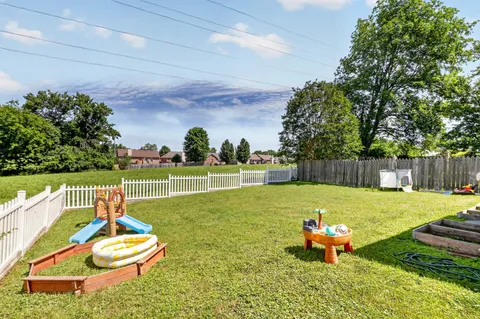 a backyard of a house with table and chairs
