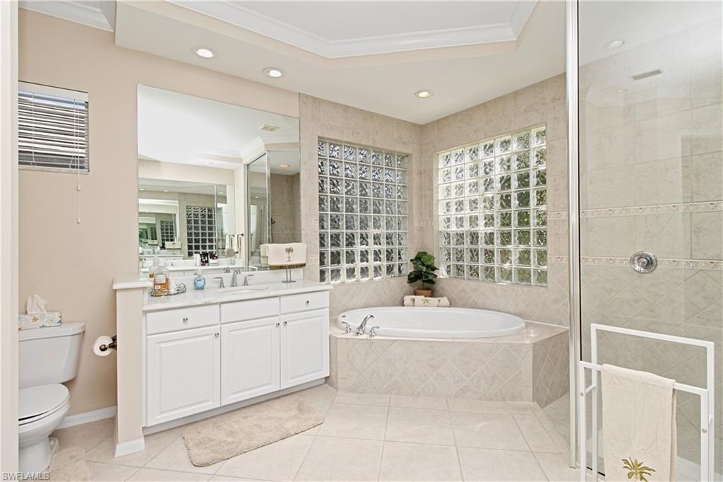 1901 Winding Oaks Way Naples, FL 34109 - Photo 11 of 21 a bathroom with a granite countertop bathtub sink vanity mirror and toilet