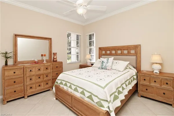 a bedroom with a bed a dresser and a mirror