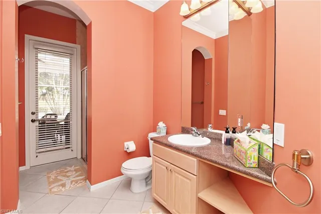 a bathroom with a granite countertop sink a toilet and a mirror