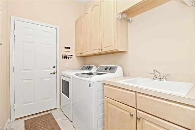 a view of a sink and washer dryer