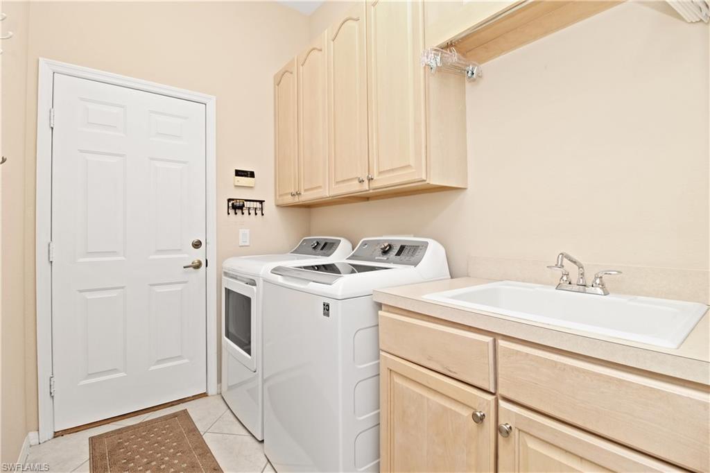 1901 Winding Oaks Way Naples, FL 34109 - Photo 19 of 21 a view of a sink and washer dryer