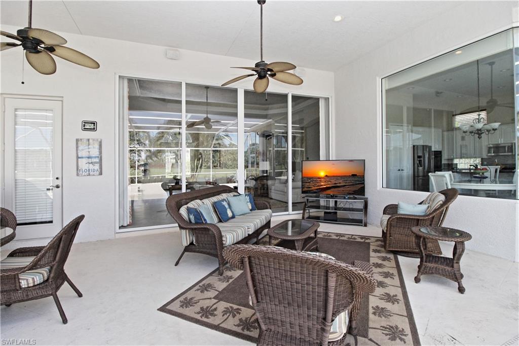 1901 Winding Oaks Way Naples, FL 34109 - Photo 2 of 21 a living room with furniture a rug and a flat screen tv
