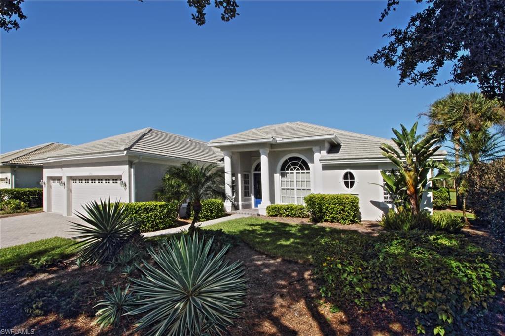 1901 Winding Oaks Way Naples, FL 34109 - Photo 5 of 21 a front view of a house with garden
