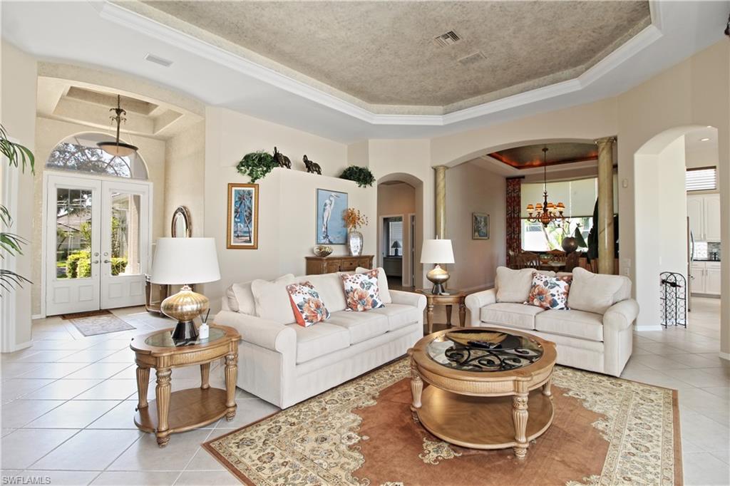 1901 Winding Oaks Way Naples, FL 34109 - Photo 7 of 21 a living room with furniture and a chandelier