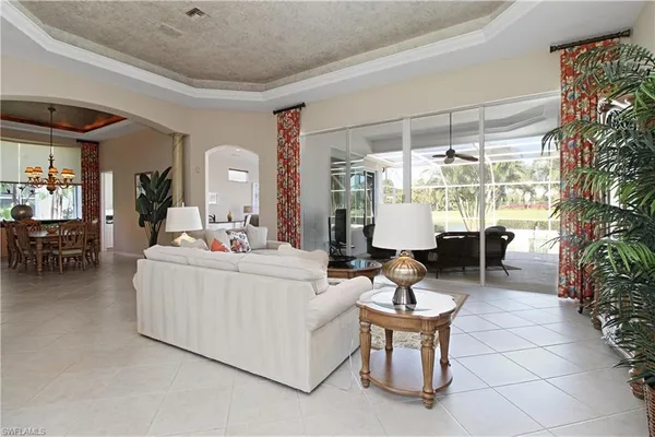 a living room with fireplace furniture and a large window
