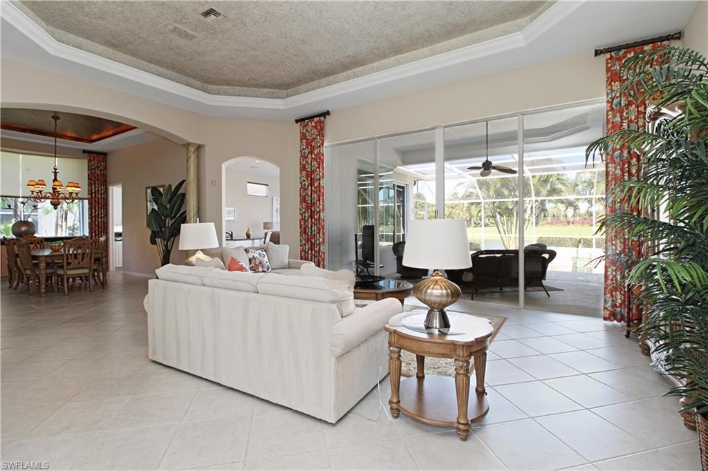 1901 Winding Oaks Way Naples, FL 34109 - Photo 8 of 21 a living room with fireplace furniture and a large window