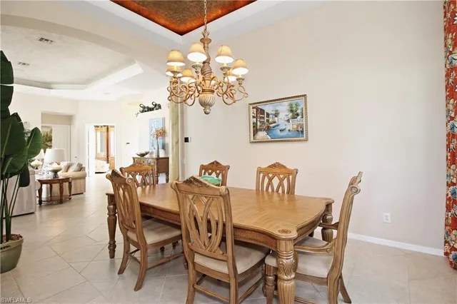 a view of a dining room with furniture and chandelier