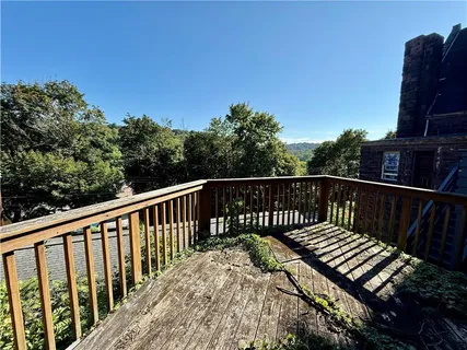 a balcony with wooden floor in front of it