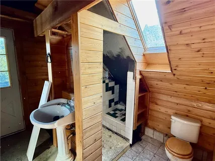 a bathroom with a toilet and a shower