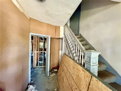 a view of an entryway with wooden floor and stairs