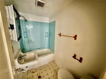 a kitchen with stainless steel appliances granite countertop a sink and a stove