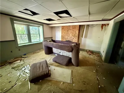 a bedroom with furniture and a window