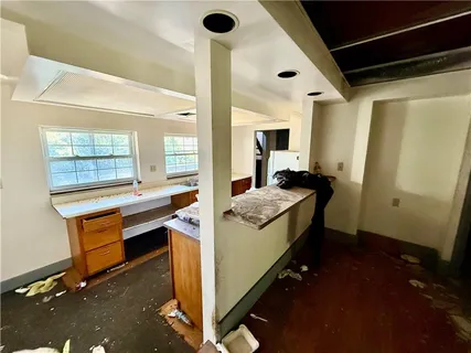 a kitchen with sink and view of living room