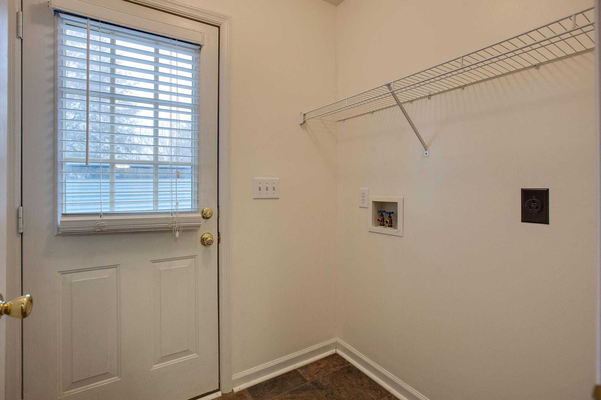 1989 Lasea Road Spring Hill, TN 37174 - Photo 14 of 17 This Laundry Room is located off the Kitchen. You have a 3rd exterior door here and this room has an interior door so guests don't have to have a view in!
