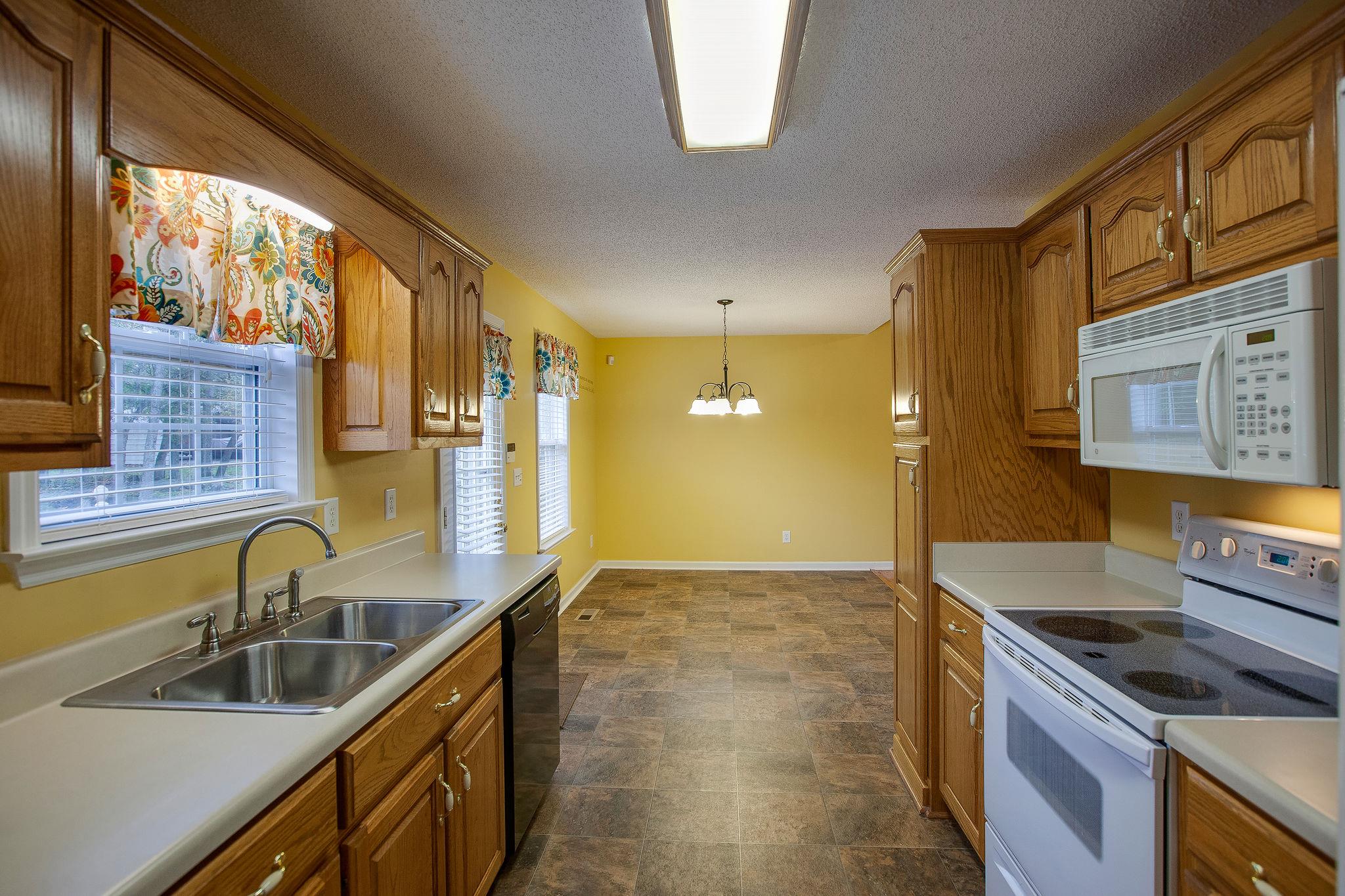 1989 Lasea Road Spring Hill, TN 37174 - Photo 6 of 17 Kitchen is open to the Dining Room and the window overlooks your private backyard!