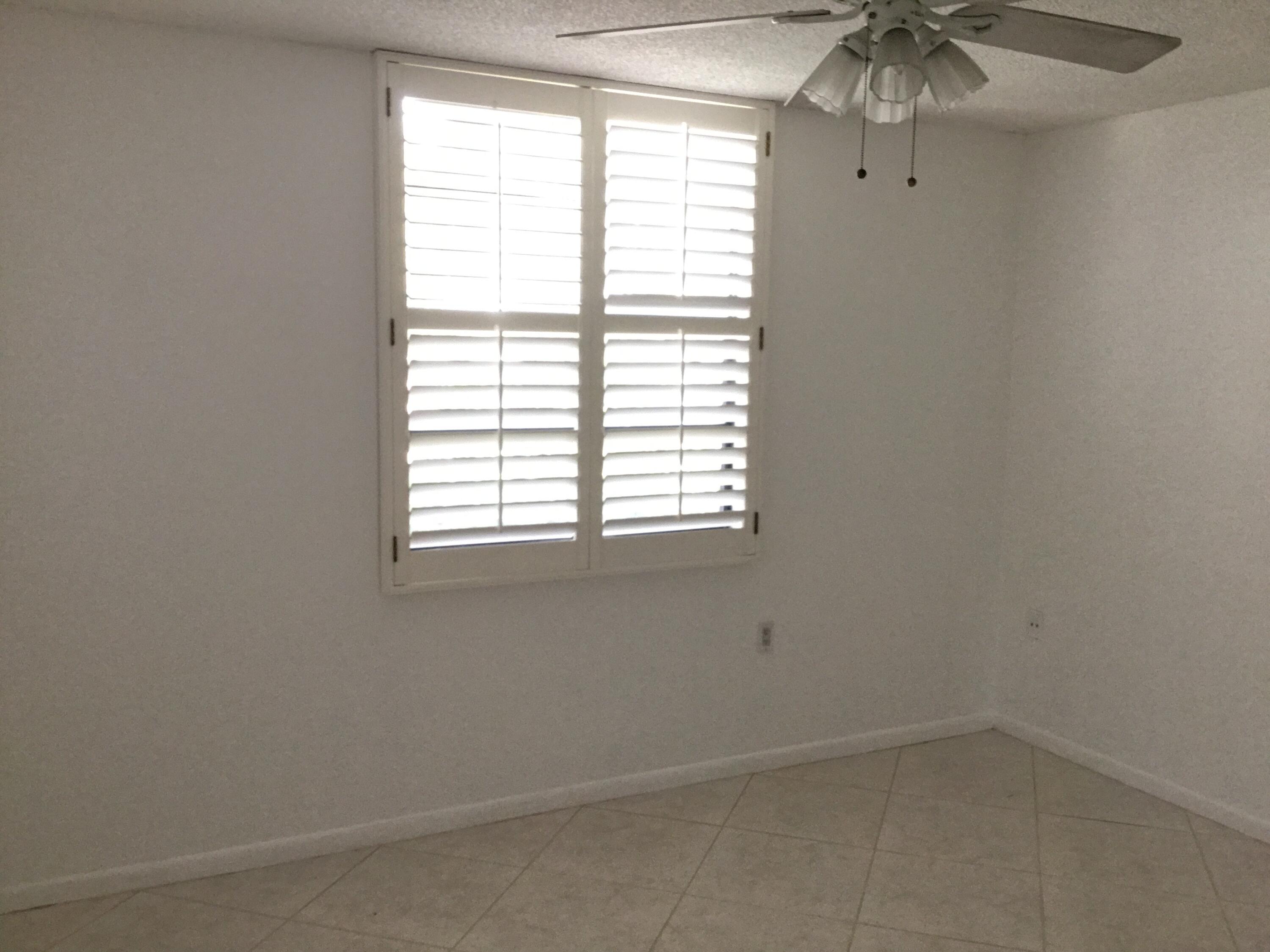 3636 Whitehall Drive, Unit 101 West Palm Beach, FL 33401 - Photo 12 of 16 an empty room with a window